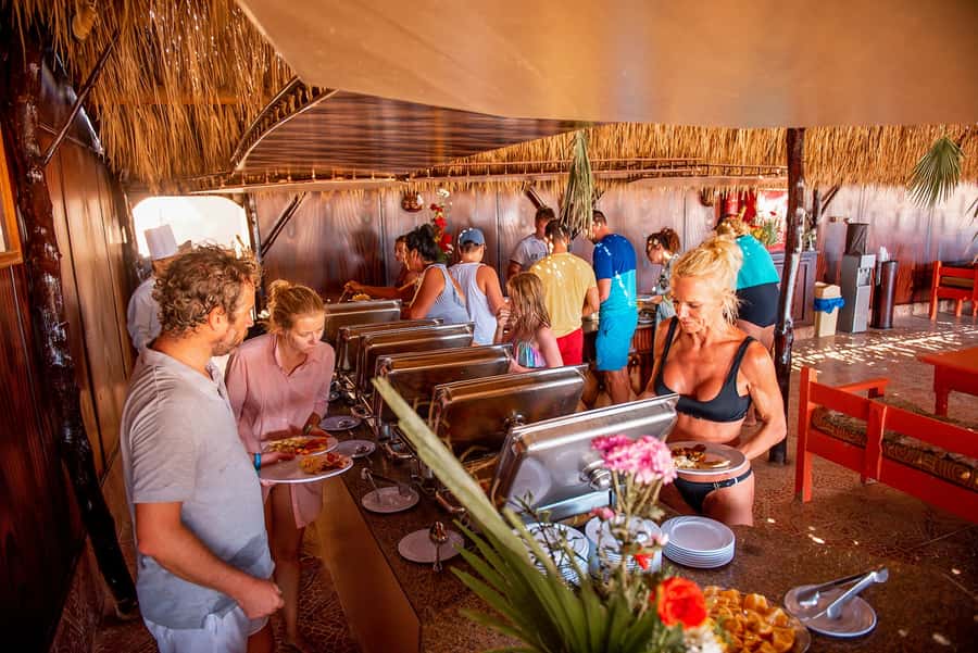 From Hurghada: Paradise Island Snorkeling Cruise with Lunch - Boat atmosphere, crew care, and photography