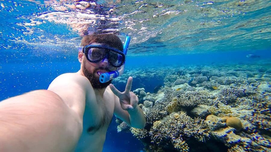 Hurghada: Orange Bay Day Trip with Water Sports and Lunch - First snorkeling stop: coral, fish, and confidence